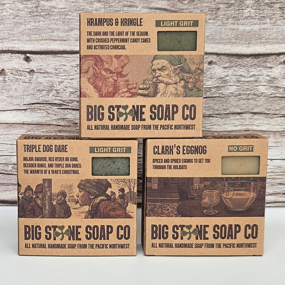 Limited Edition Christmas Bundle flat lay of Triple Dog Dare, Clark's Eggnog, and Krampus & Kringle soap boxes