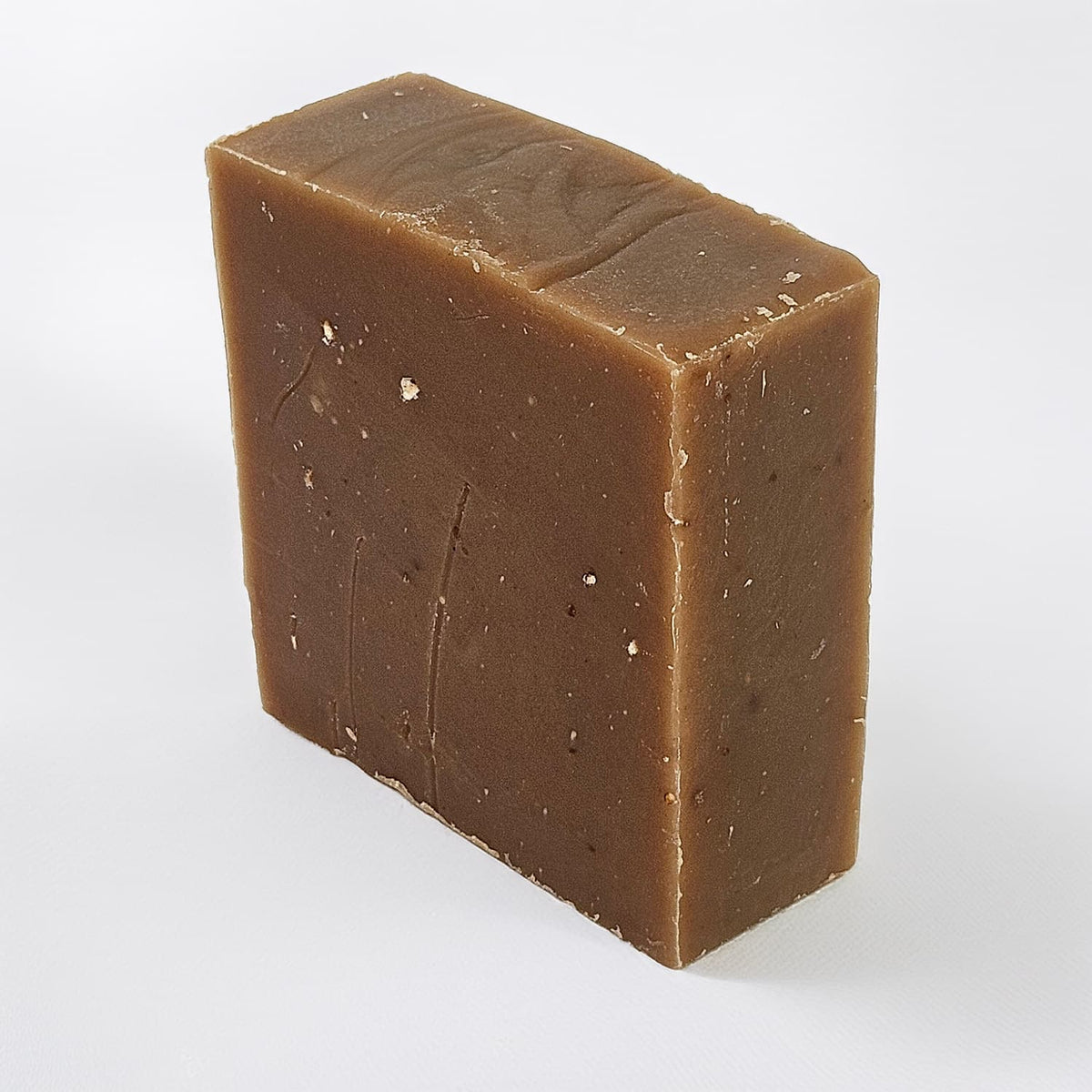 Unboxed bar of Oatmeal Stout natural handmade soap, a pub-inspired medium-grit bar with rolled oats