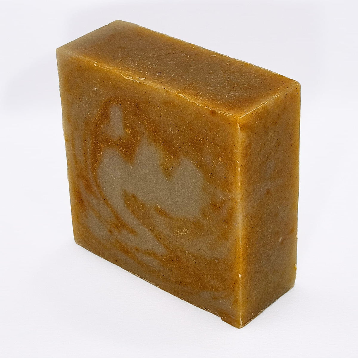 Unboxed bar of Pirates Never Say Die natural handmade soap, a pirate-themed bar with crushed crystal quartz and annatto seed
